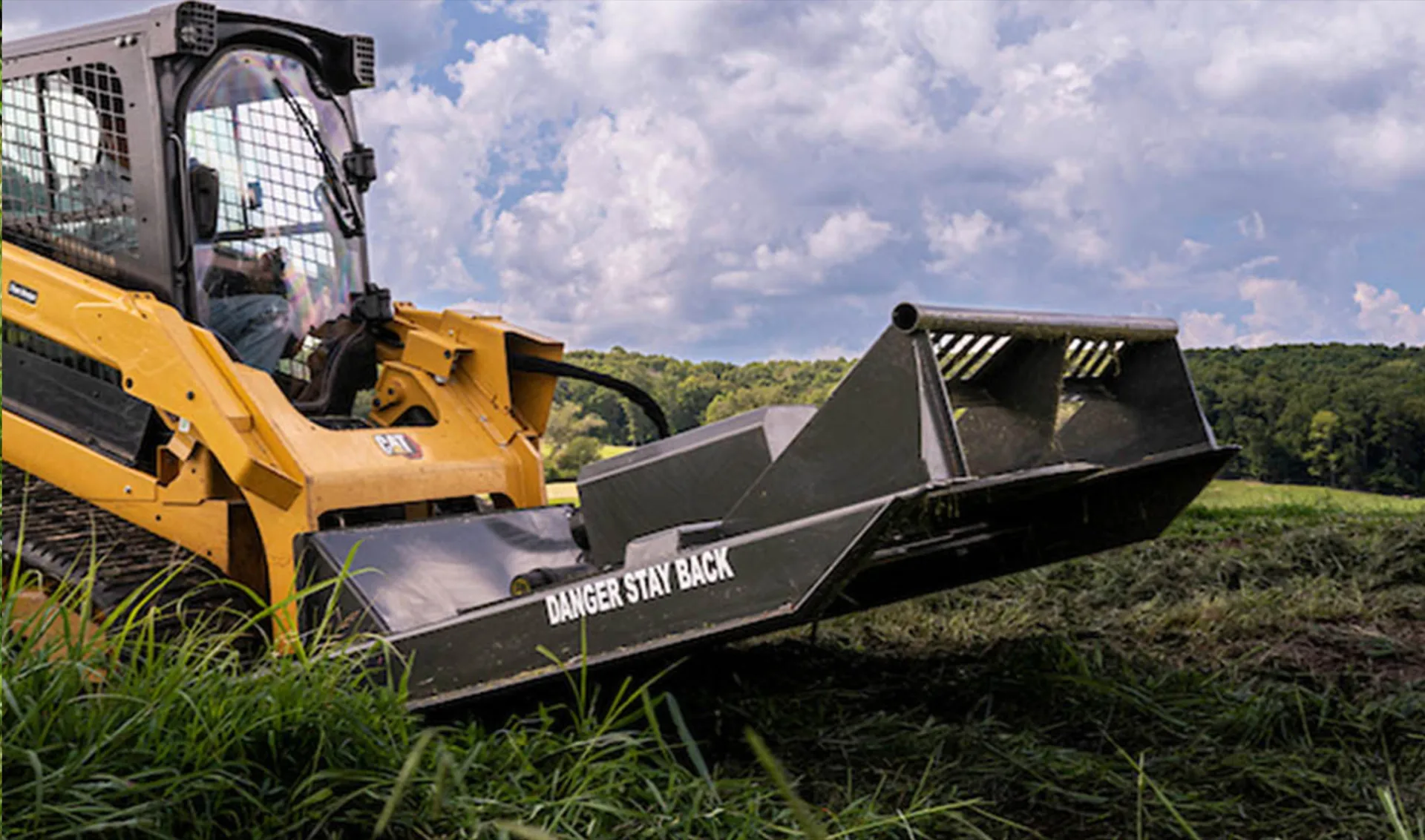 Skid steer clearing land on a property near Rexburg, Idaho